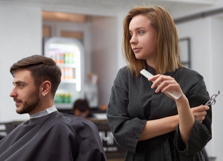 Man met baard en snor bij de kapster