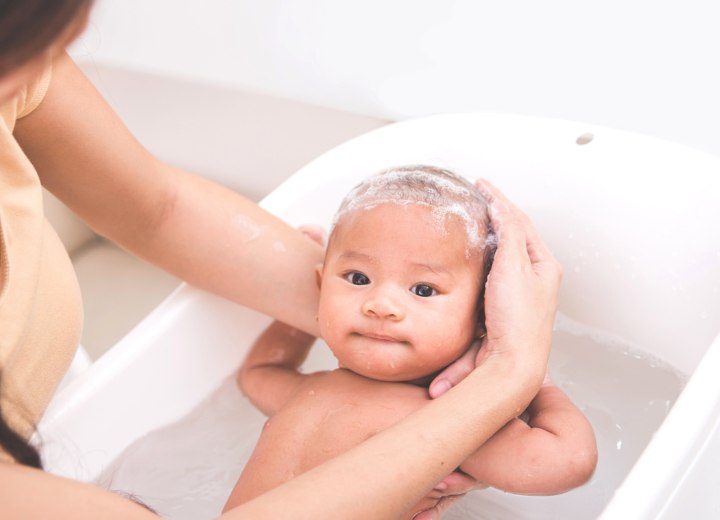 Hoe het hoofd van een baby in bad ondersteunen